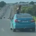 Passageira é flagrada no teto solar de carro, na BR-153